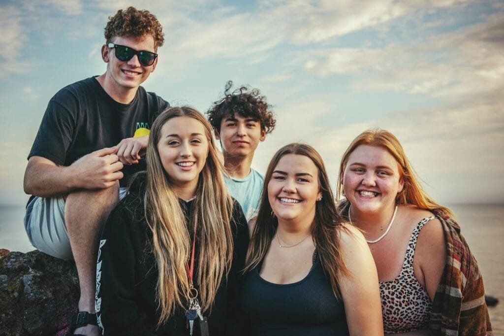 pexels-photo-3063478 Happy young friends posing and smiling together at Avila Beach, California during a sunny day.